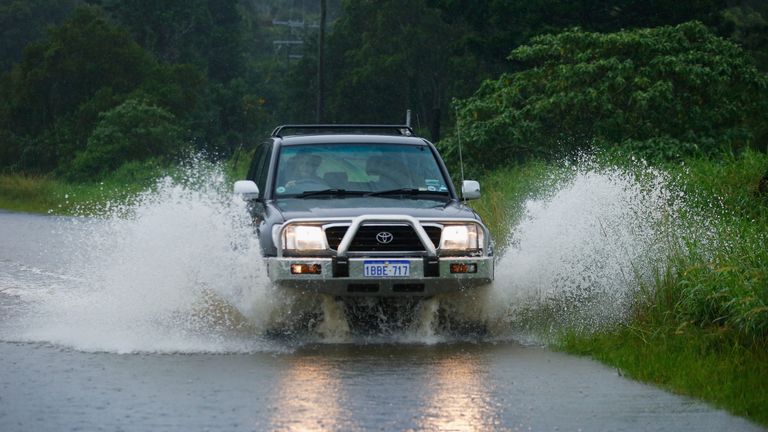 A car drives through water in Billinudgel