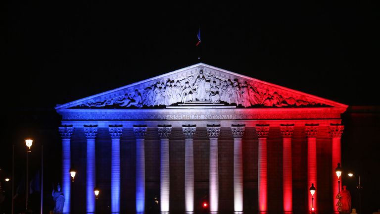 France&#39;s National Assembly is lit up in the colours of the French flag