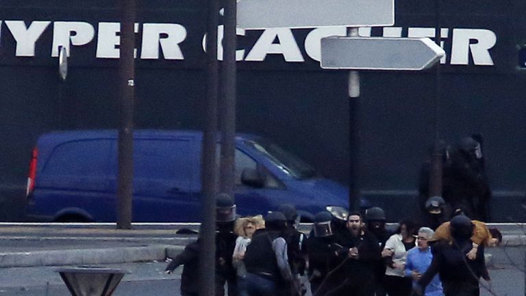 Hostages are escorted out of a kosher grocery store in Porte de Vincennes