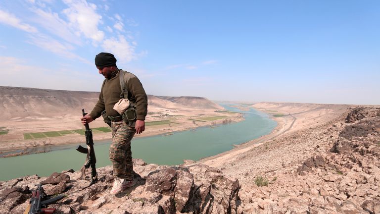 A Syrian Democratic Forces fighter poses for a picture near Euphrates River, north of Raqqa city