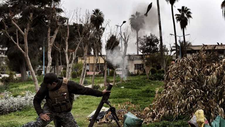 A member of the Iraqi security forces fires mortars towards jihadists positions in west Mosul