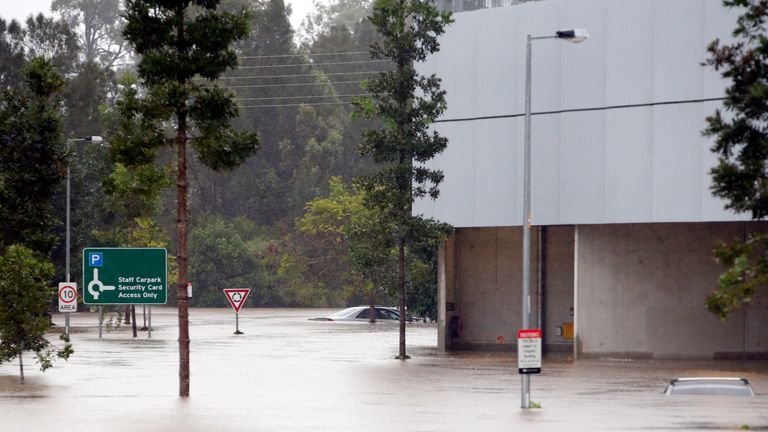 Flood waters enter in the parking lot outside the Robina Hospital on the Gold Coast
