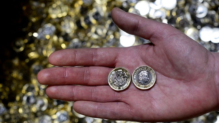 New one pound coins are displayed The Royal Mint