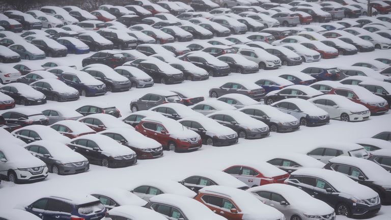 Vehicles in a car park in Norristown, Pennsylvania, are covered in snow