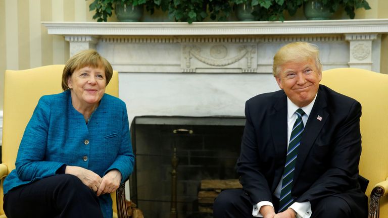 Angela Merkel and Donald Trump smile for the cameras in the Oval Office