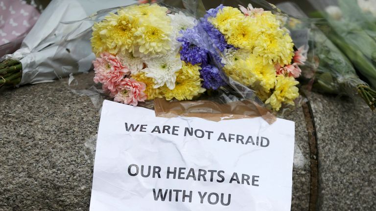 Flowers and messages are left near the scene of an attack by a man driving a car and weilding a knife left five people dead and dozens injured, in London