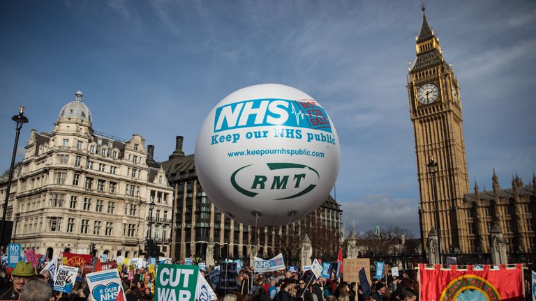 Protesters holding placards gather during a demonstration in support of the NHS
