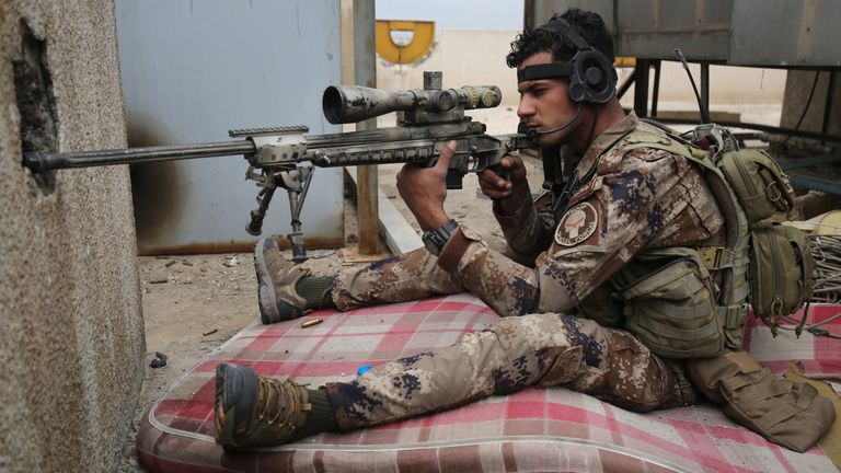 A sniper takes aim during the advance into the Old City in west Mosul