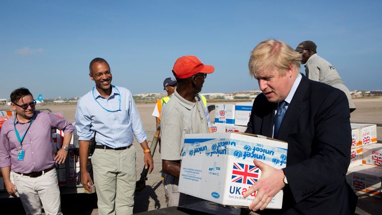 Britain&#39;s Foreign Secretary Boris Johnson helps to load supplies for treating malnourished children affected by the severe drought in Somalia onto a cargo plane at Mogadishu International Airport in Mogadishu, Somalia March 15, 2017