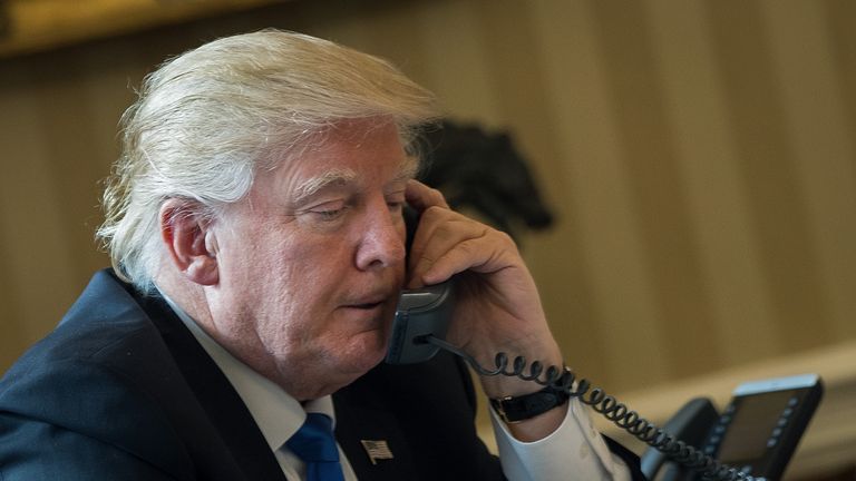 Donald Trump makes a call in the White House. File picture