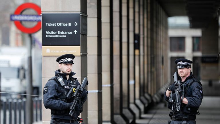 Armed police officers patrol outside Westminster underground station