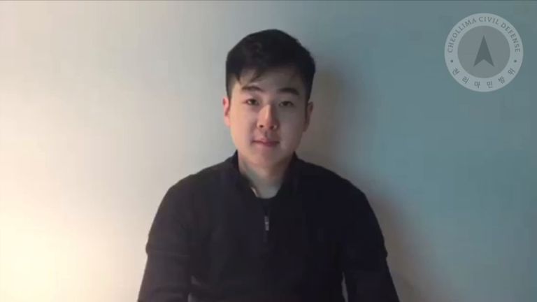 Kim Han-Sol shows his North Korean passport in the video footage
