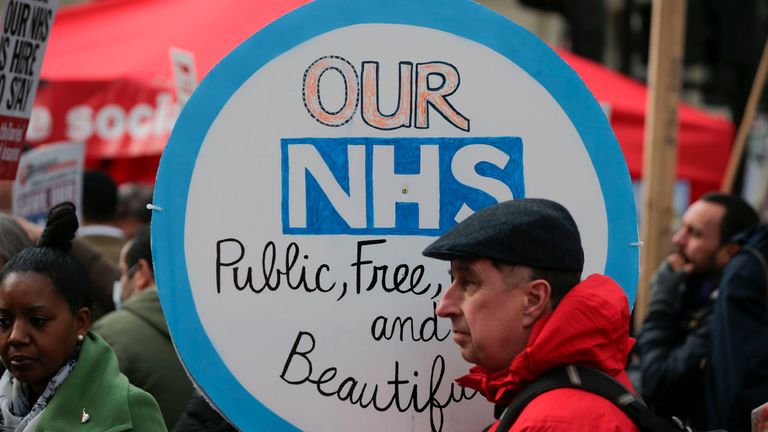 A protester holds a placard during a march against private companies&#39; involvement in the National Health Service (NHS) and social care services provision and against cuts to NHS funding in central London on March 4, 2017. People gathered to demonstrate at the rally publicised by the People&#39;s Assembly Against Austerity to demand a fully and publicly funded NHS and social care service, returned fully to public ownership and provision and to say no to cuts in NHS funding