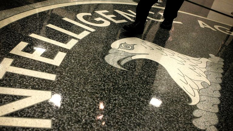 A man walks across the seal of the Central Intelligence Agency