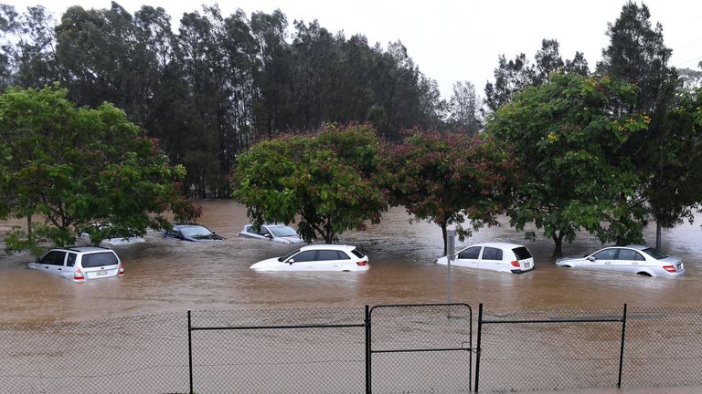 Cars sit submerged after heavy rain associated with Cyclone Debbie hit the Gold Coast suburb of Robina in Queensland, Australia