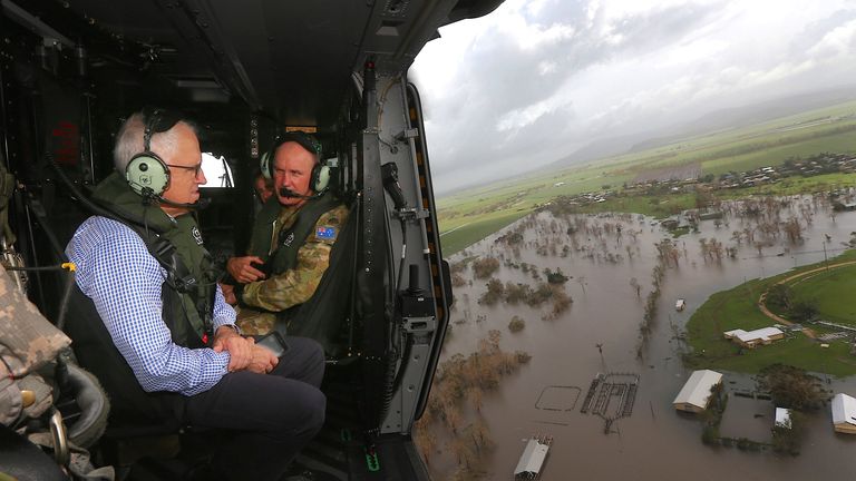 Australian Prime Minister Malcolm Turnbull looks at damaged and flooded areas from aboard an Australian Army helicopter 