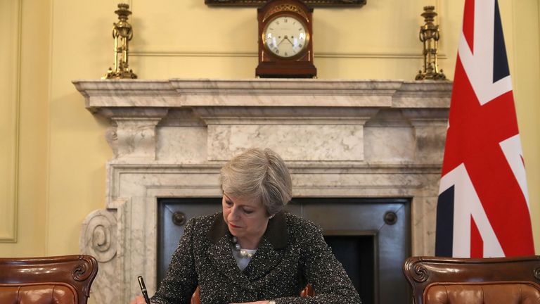 Prime Minister Theresa May in the cabinet signs the Article 50 letter, as she prepares to trigger the start of the UK&#39;s formal withdrawal from the EU on Wednesday.
Read less