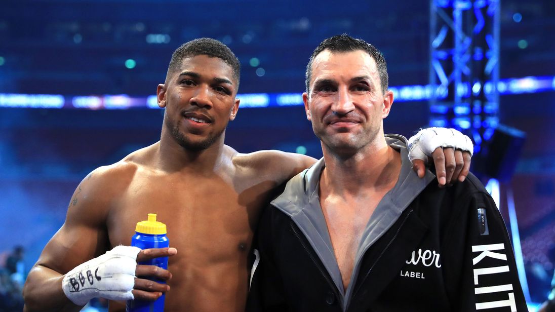 Anthony Joshua stands with Wladimir Klitschko following the IBF, WBA and IBO Heavyweight World Title bout