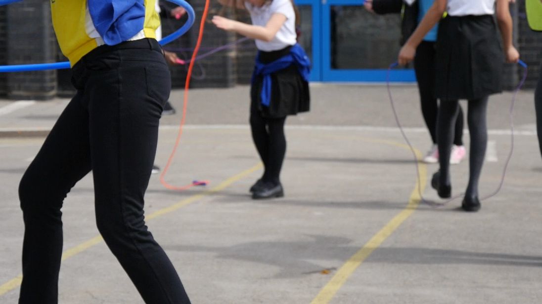 Anon school children playing in playground.