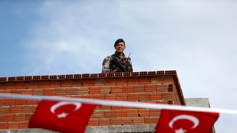 A security officer on a roof near a polling station in the Aegean port city of Izmir