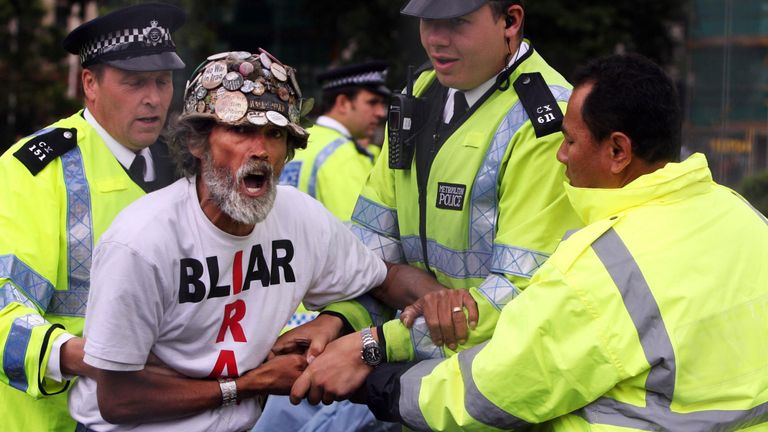 Peace campaigner Brian Haw with police after letters were issued to campers asking them to leave Parliament Square in 2007