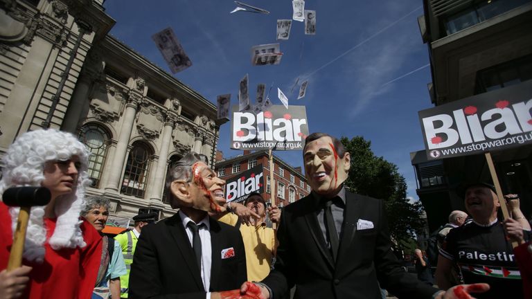 Demonstrators protest outside QEII Centre in London on July 6, 2016, as they wait to hear the outcome of the Iraq Inquiry