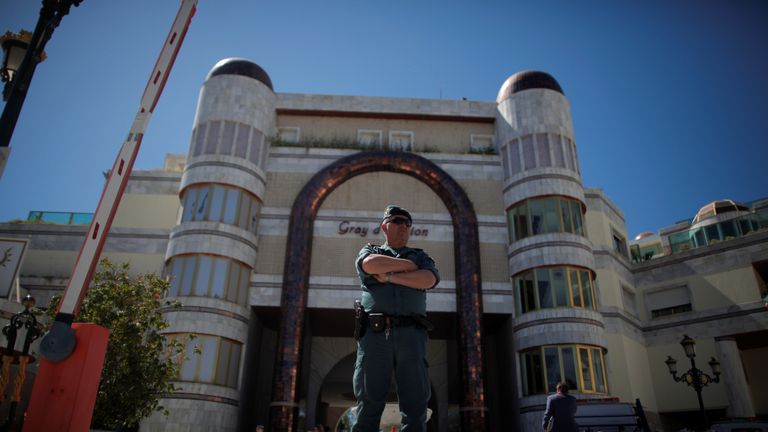 A Spanish civil guard officer stands outside one of Rifaat al Assad&#39;s seized buildings