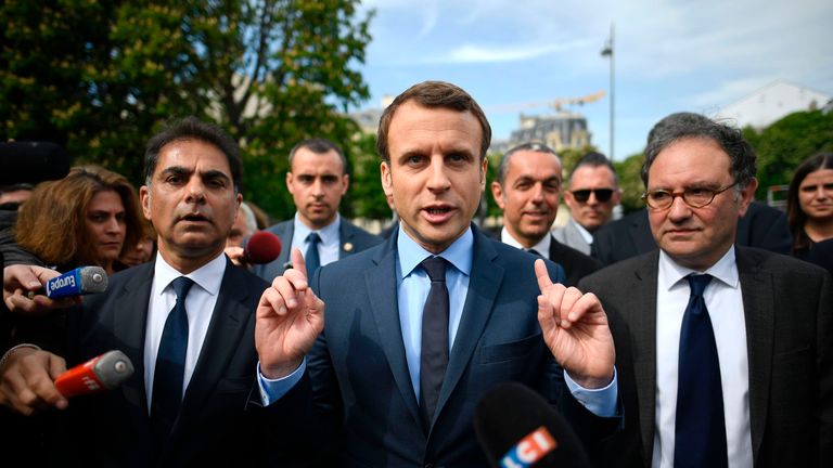 French presidential election candidate for the En Marche ! movement Emmanuel Macron (C), next to Mourad Franck Papazian (L), co-president of France's Armenian Organizations Coordination Council (CCAF, Conseil de Coordination des organisations Armenienne de France), speaks to the press after a ceremony at a monument in memory of mass killings of Armenians by Ottoman forces in 1915, on April 24, 2017 in Paris