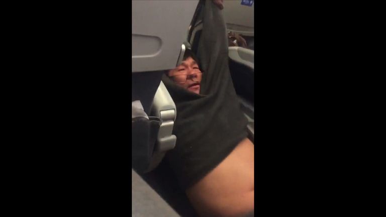 The man appeared to bang his head as he was dragged from the plane