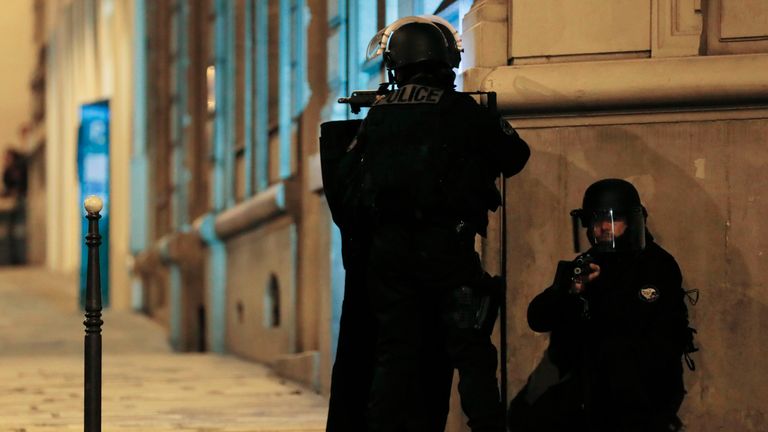 Armed police officers block the access of a street near the Champs-Elysees 
