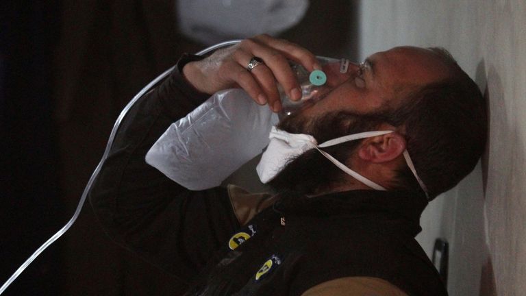 A rescue worker breathes through an oxygen mask after a &#39;chemical attack&#39; in Idlib