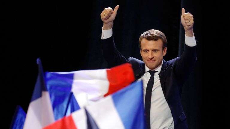 Emmanuel Macron celebrates topping the first round of the election