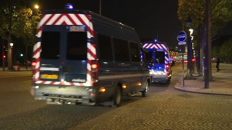French police vehicles drive in convoy through Paris streets after shooting incident