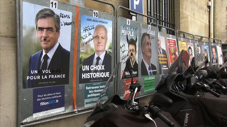 Defaced posters of the election candidates shows the apathy and division