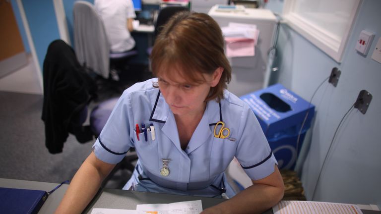 A nurse writes up her case notes at a work station in the recently opened Birmingham Queen Elizabeth Hospital on February 7, 2011