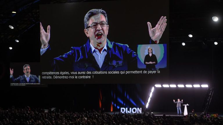 Jean-Luc Melenchon delivers a speech on stage in Dijon