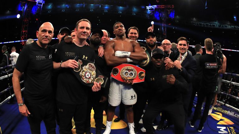 Joshua celebrates with his team following his victory