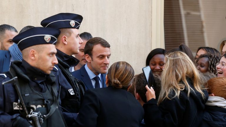 Emmanuel Macron was mobbed by supporters as he left his Paris home on Monday morning