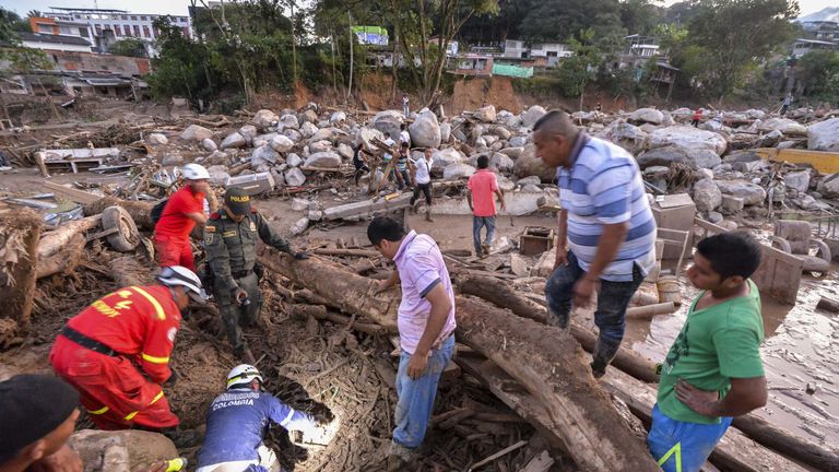 Rescuers seek people among the rubble left by mudslides following heavy rains in Mocoa, Putumayo department, southern Colombia on April 1, 2017