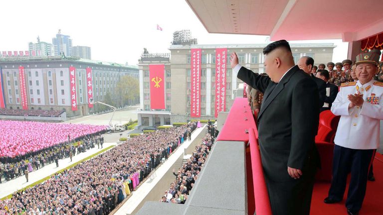 Kim Jong-Un waves to crowds following a military parade in Pyongyang