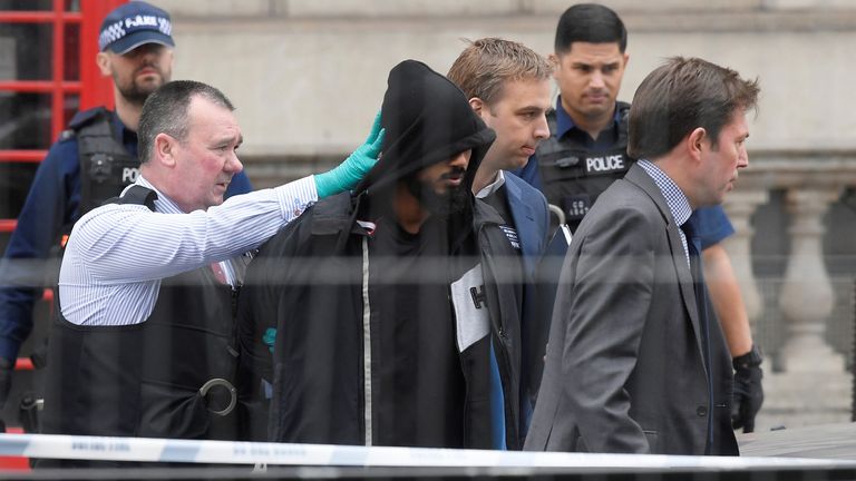 A man is led away by police in Westminster after an arrest was made on Whitehall