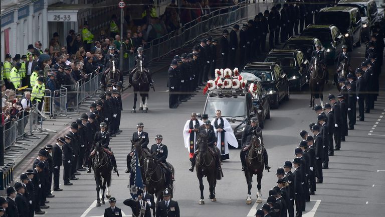 Police officers line the streets as PC Keith Palmer&#39;s coffin passes