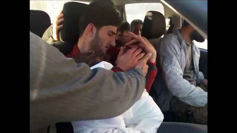 Abdel Hameed al-Youssef cradles his dead twins after the suspected chemical attack