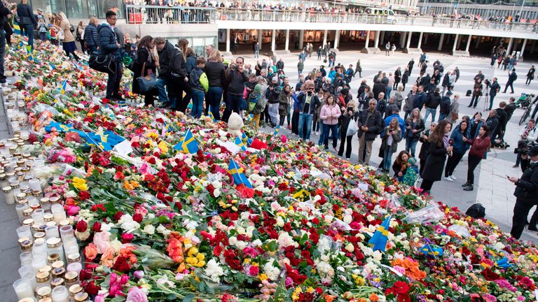 Flowers left on the steps at Sergels Torg plaza in Stockholm close to the point where a truck drove into a department store