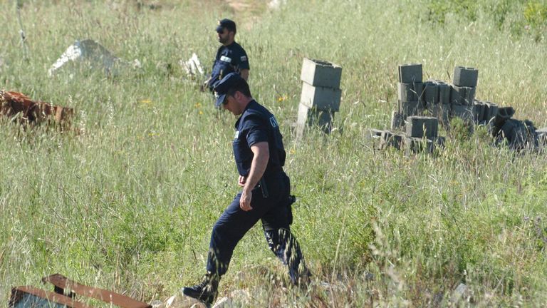 2007: Police looking for Madeleine McCann search the field near Luzt Portugal