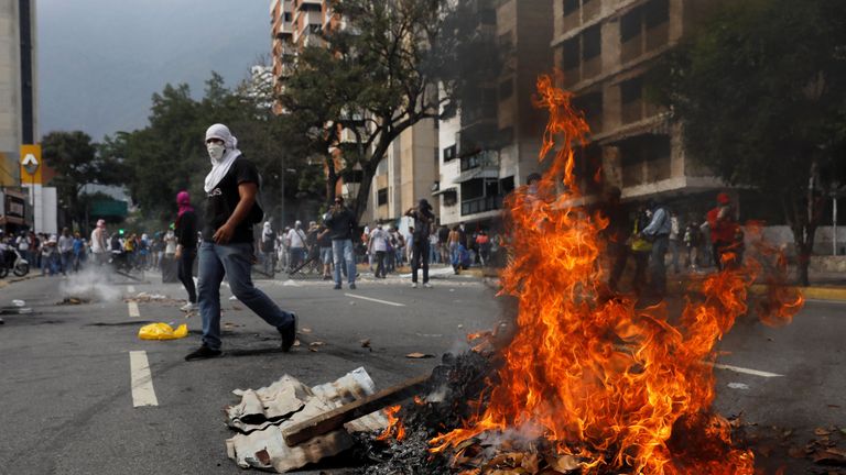 Opposition supporters clash with police during protests against unpopular leftist President Nicolas Maduro in Venezuela
