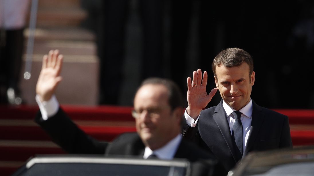 Emmanuel Macron waves off Francois Hollande as he takes over as French president