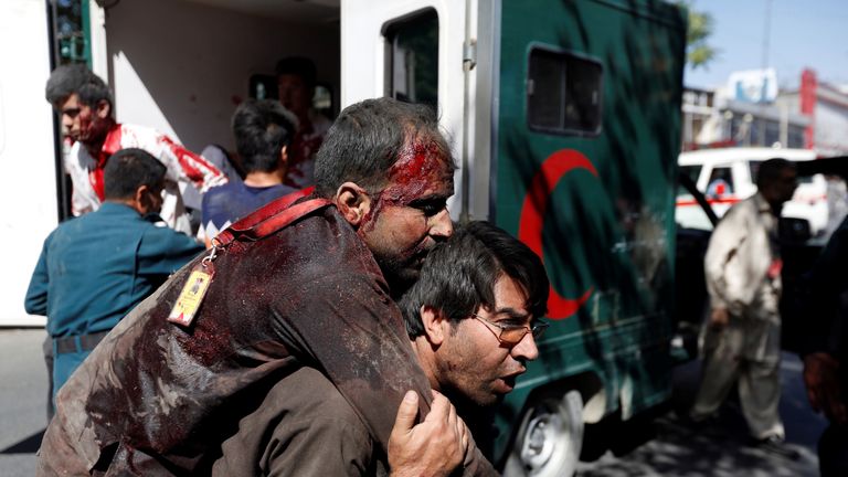 An injured man is carried to a hospital after the blast in Kabul