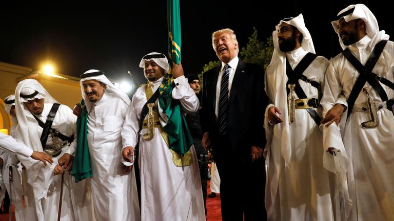 Mr Trump dances with a sword as he arrives to a welcome ceremony by King Salman