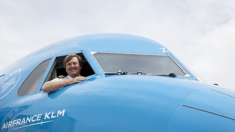 Dutch King Willem-Alexander looking out from the window of a KLM Cityhopper aircraft at Schiphol Airport, near Amsterdam
